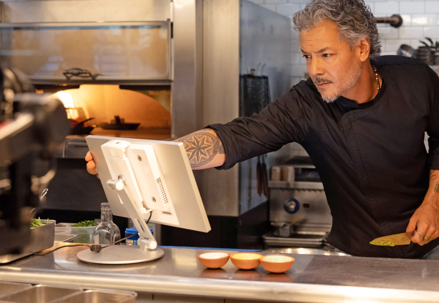 Chef checking tickets on a Clover kitchen display system