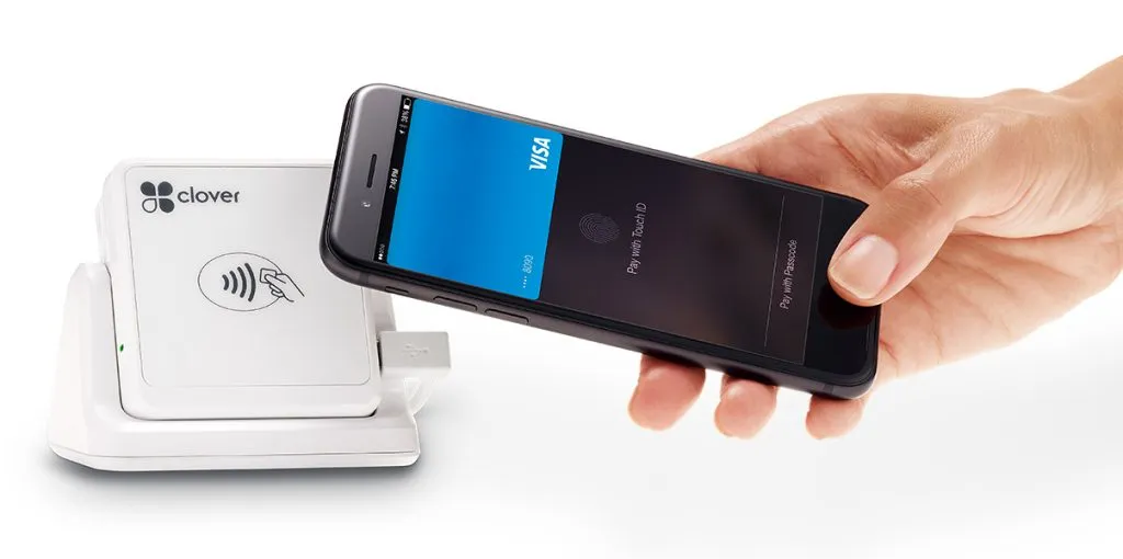 Clover Go card reader in its stand, taking a contactless phone payment