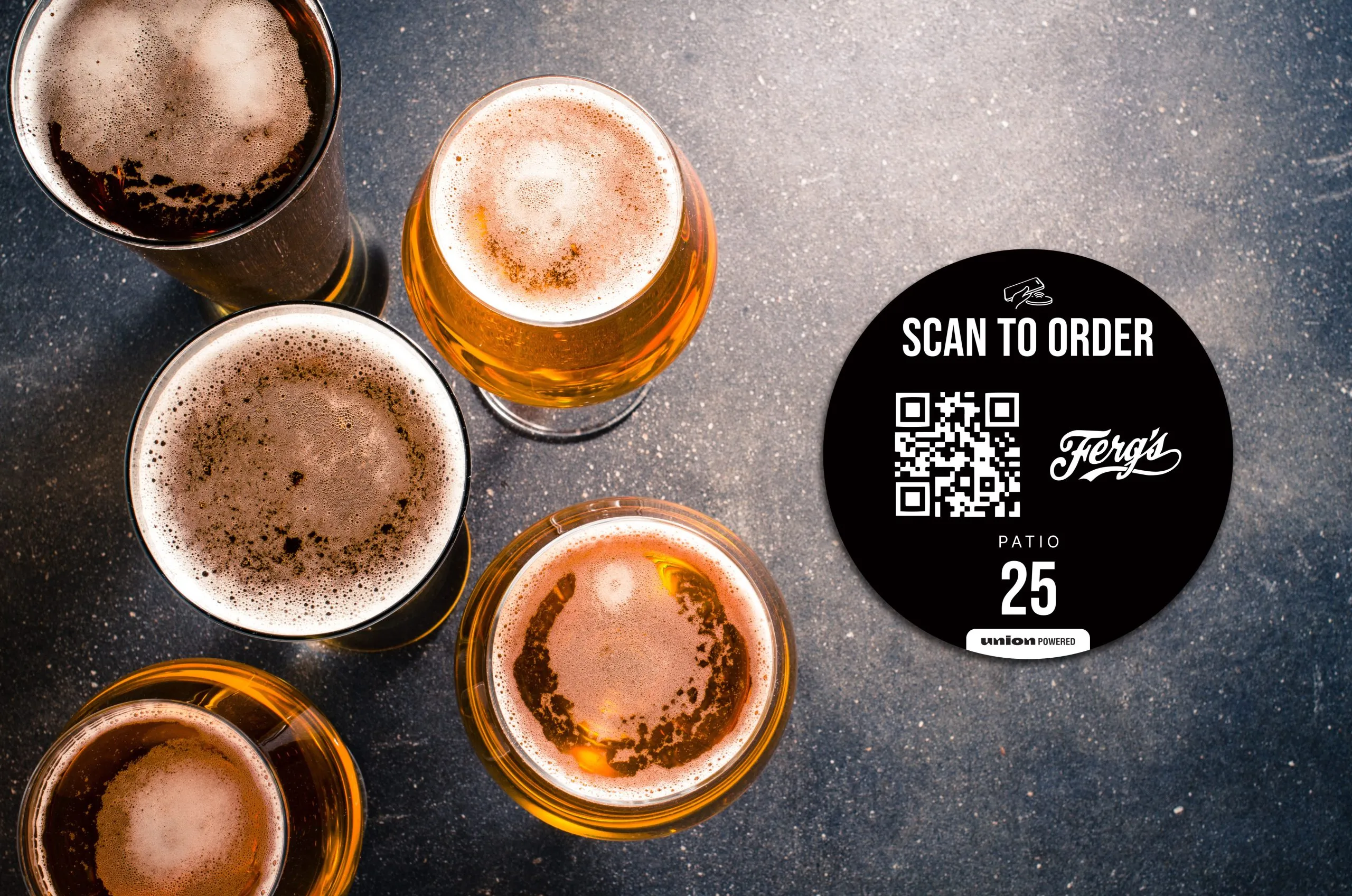 Beers on a bar table beside a scan-to-order QR coaster