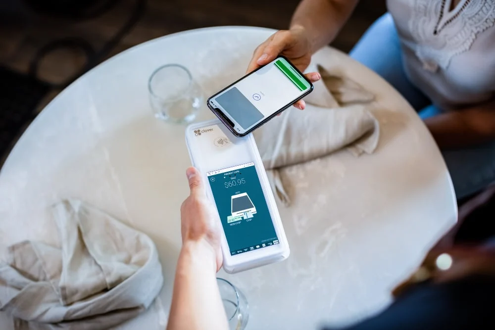 Customer paying with Apple Pay on a Clover Flex handheld