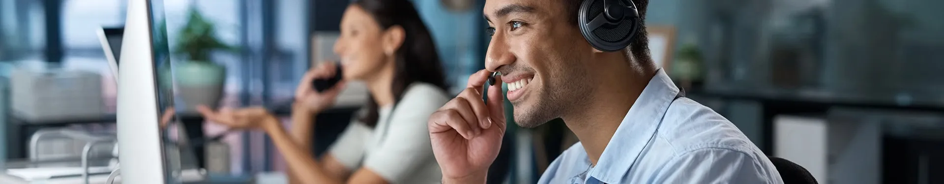 Support agents wearing headsets at their desks