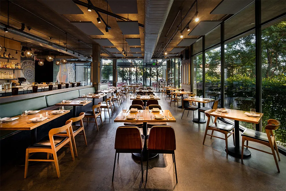 Dining room of a modern restaurant with tables set for service